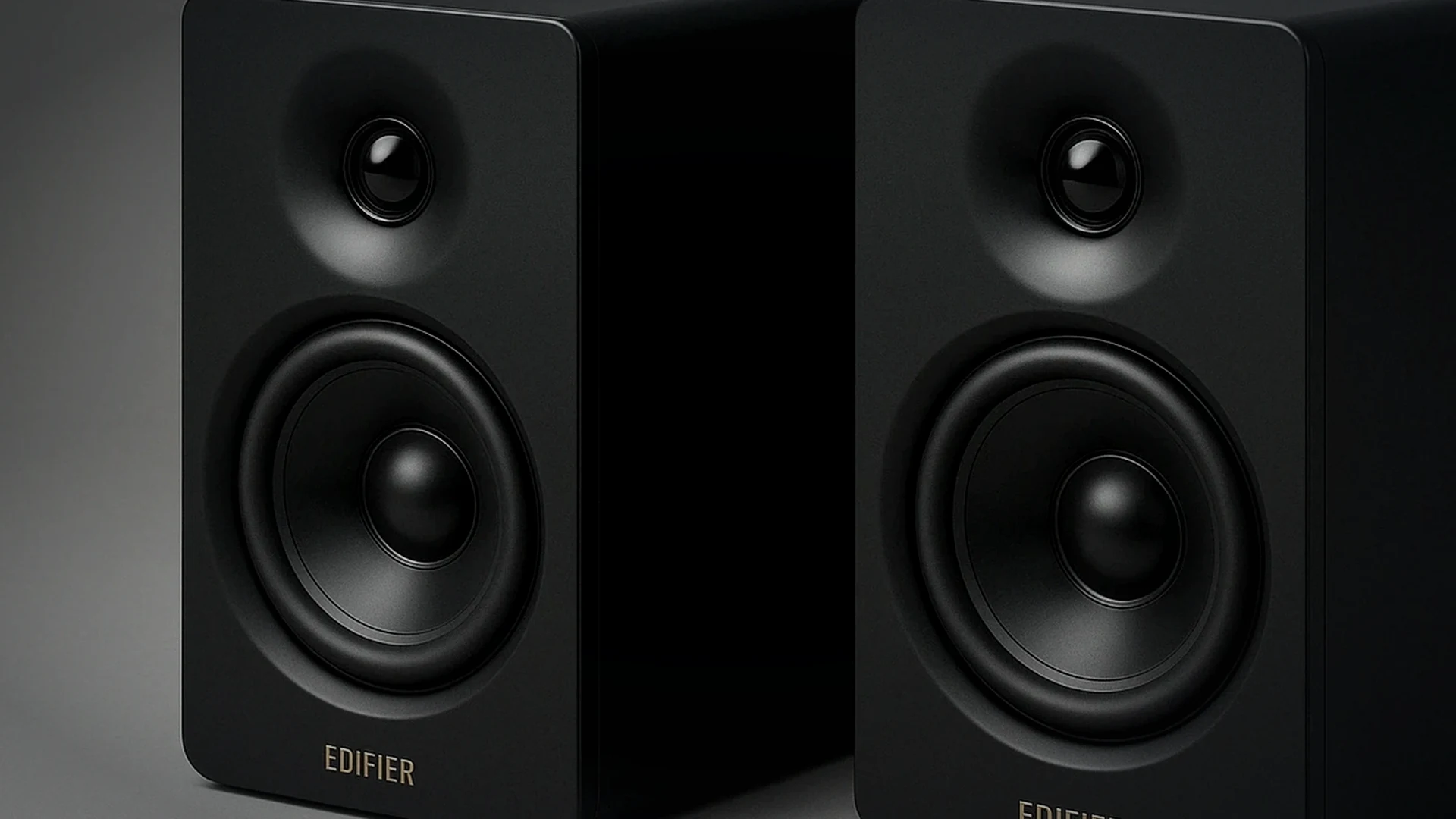 Compact budget desktop speakers and a low-profile soundbar arranged on a realistic gaming desk